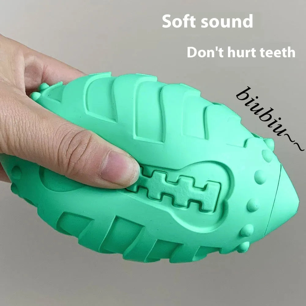 Light green rubber rugby ball dog toy with textured teeth cleaning surface