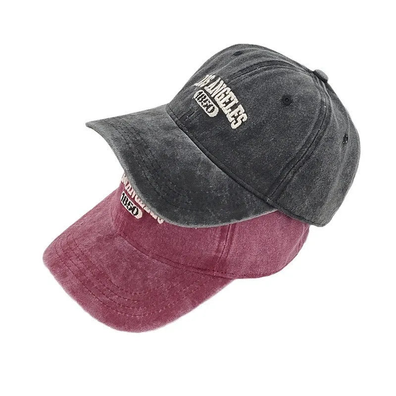 Retro personalised adjustable peaked cap showing distressed letters embroidery on conical crown