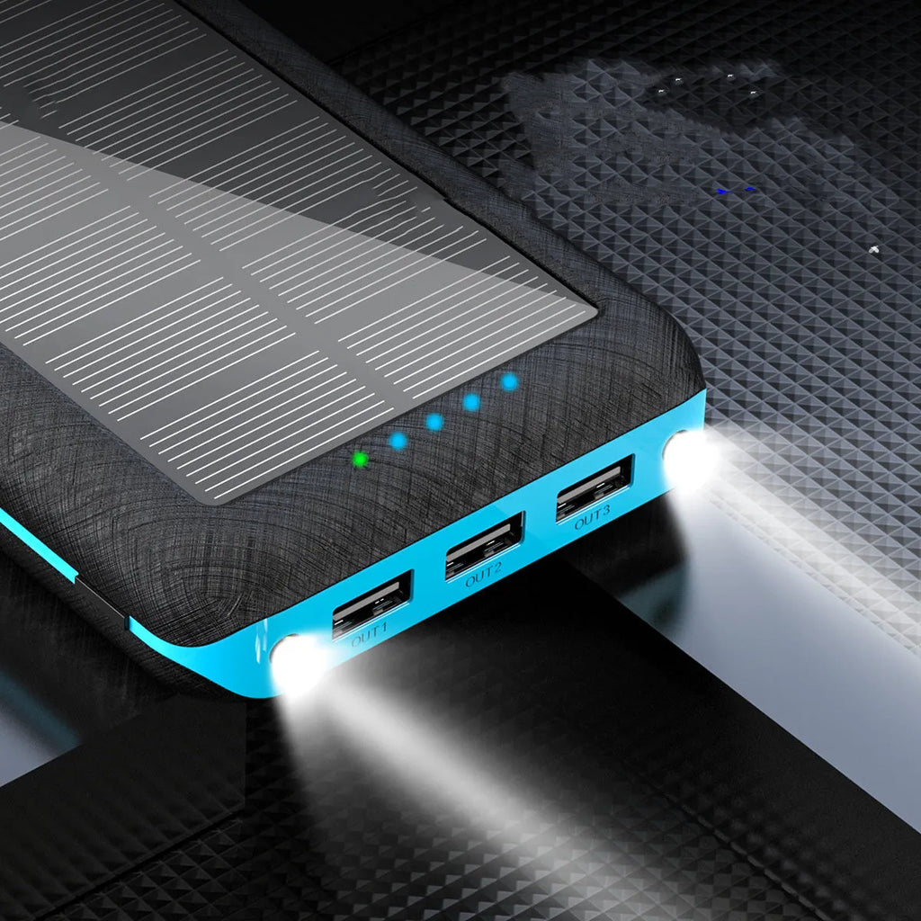 Black portable power bank with wireless charging surface and three USB ports for multiple device charging