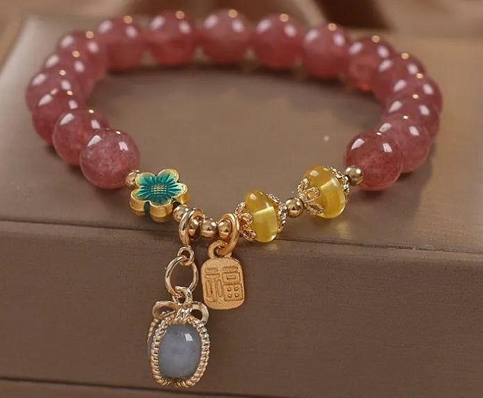 Red strawberry quartz bead bracelet with alloy chain and sparkling rhinestone details.