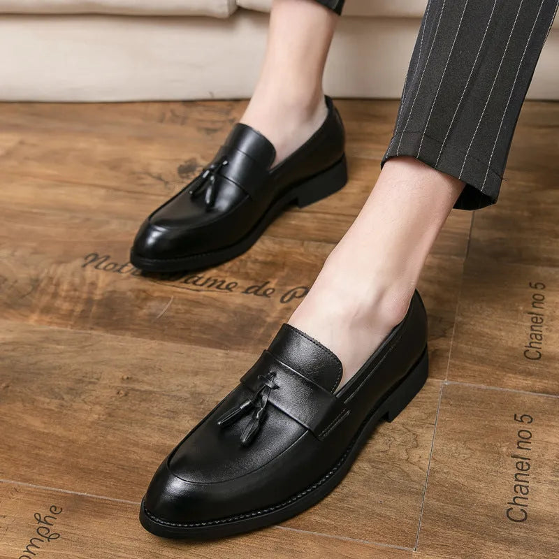 Men's black slip-on tassel loafers with low-top design and rubber sole for business casual wear