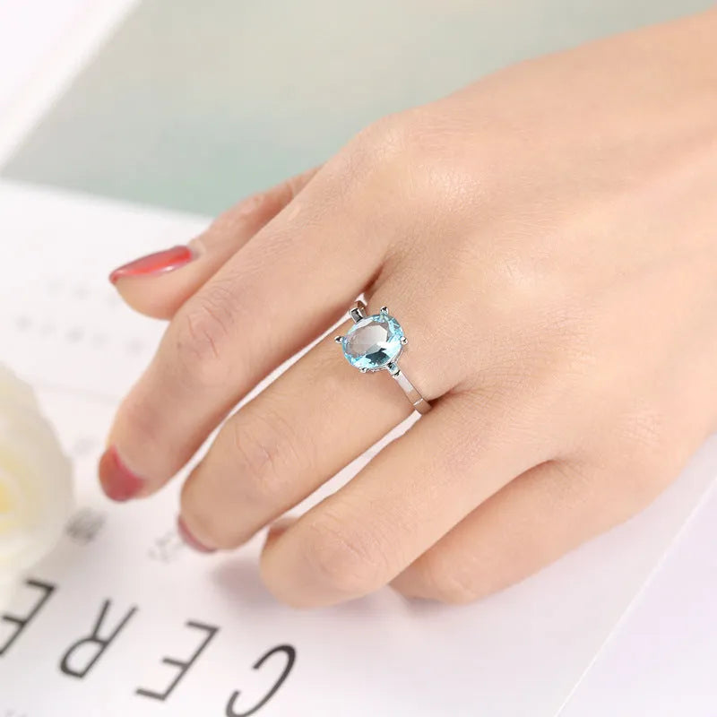 Ocean blue zircon copper ring with geometric shape and electroplated finish in women's sizes No 6 to No 10