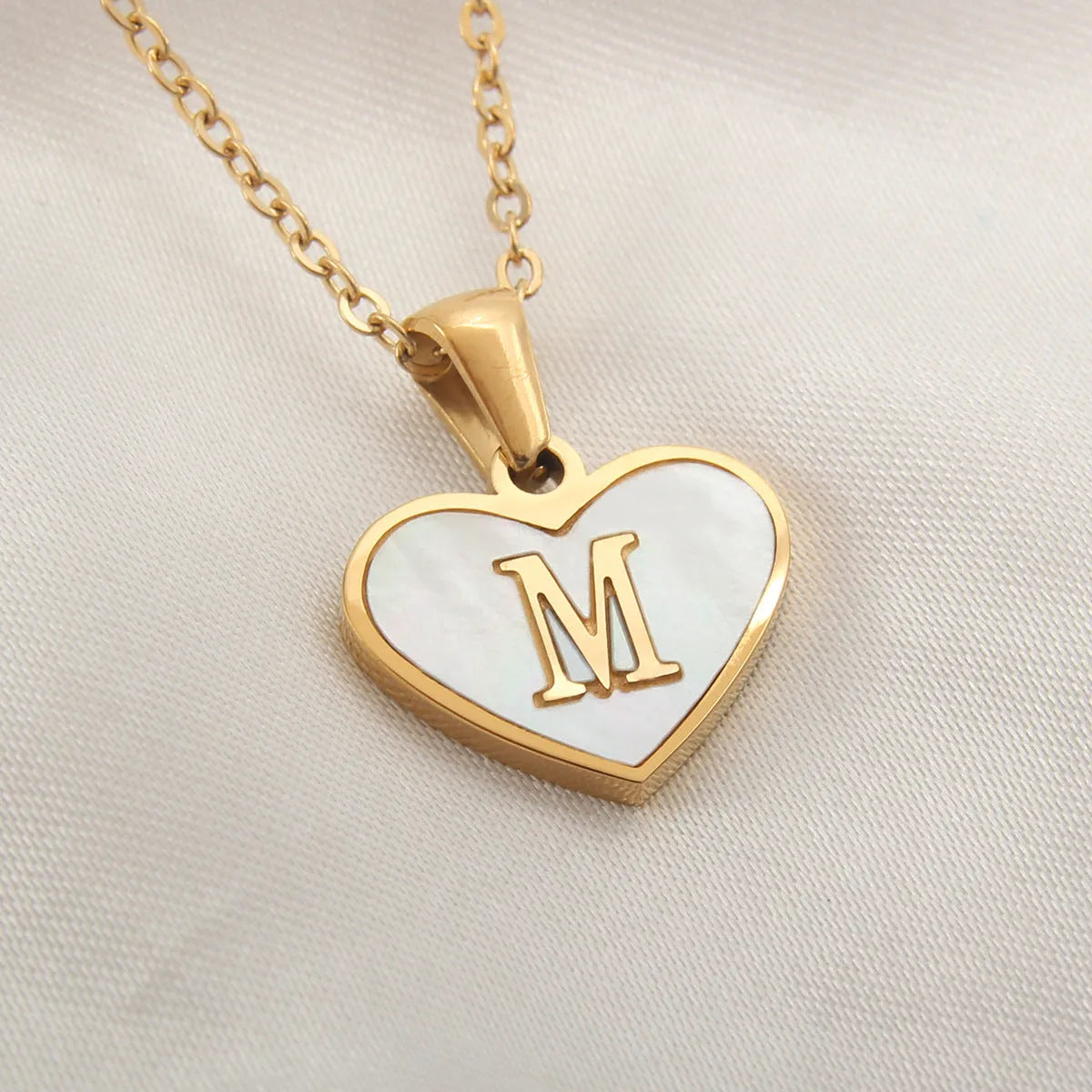 Gold plated heart necklace with white shell detail on an adjustable chain