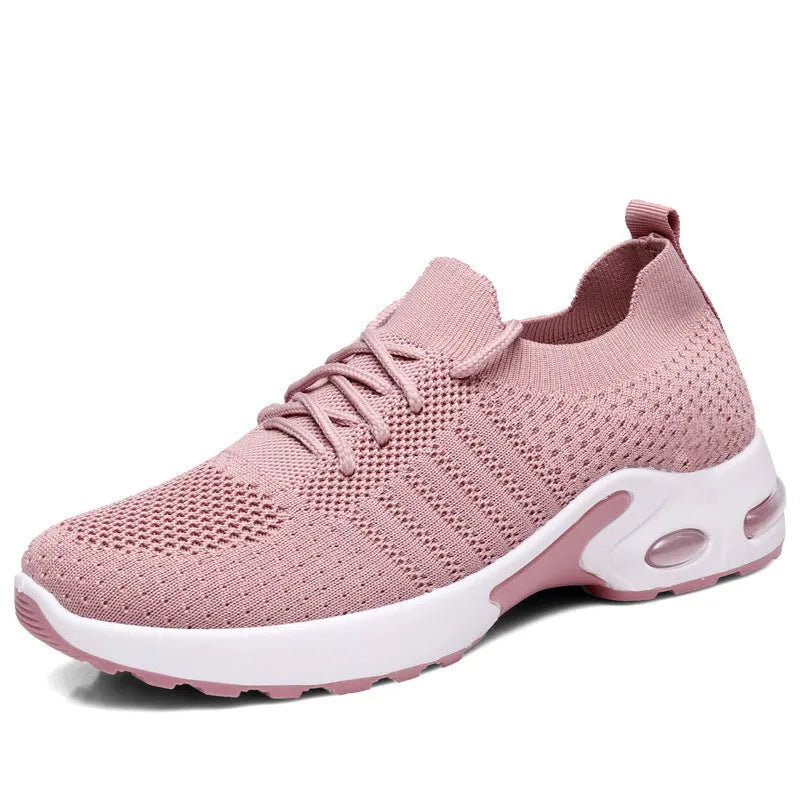 Women's solid colour casual sneaker with mesh upper, round toe, and front laces.