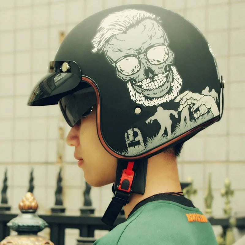 Retro-style black and orange open-face motorcycle half helmet for adults on a white background.