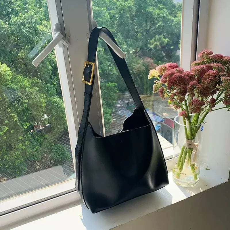 Women's soft PU leather shoulder bag with swing threads detail in black and brown colour options
