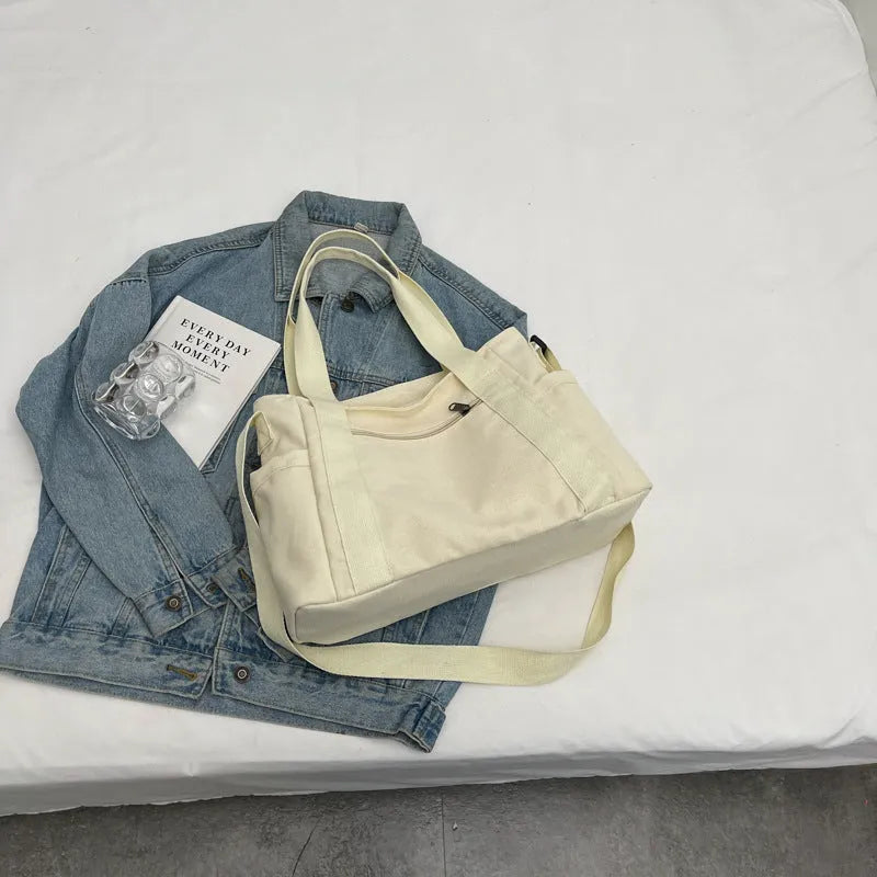 Large capacity polyester canvas shoulder bag in solid colour with sandwich pocket