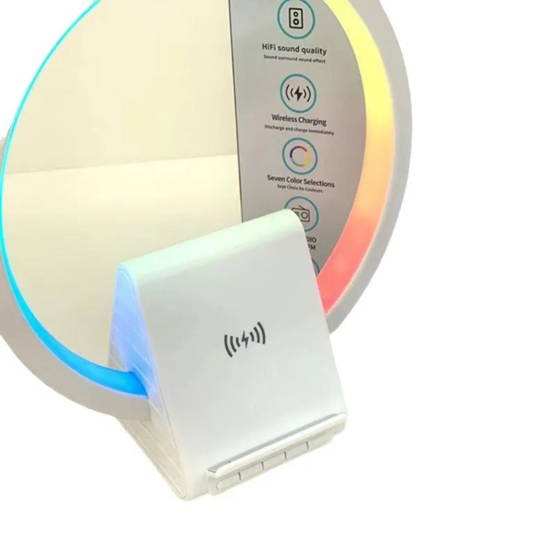 White smart Bluetooth speaker with ambient light and 15W wireless charging pad on desk