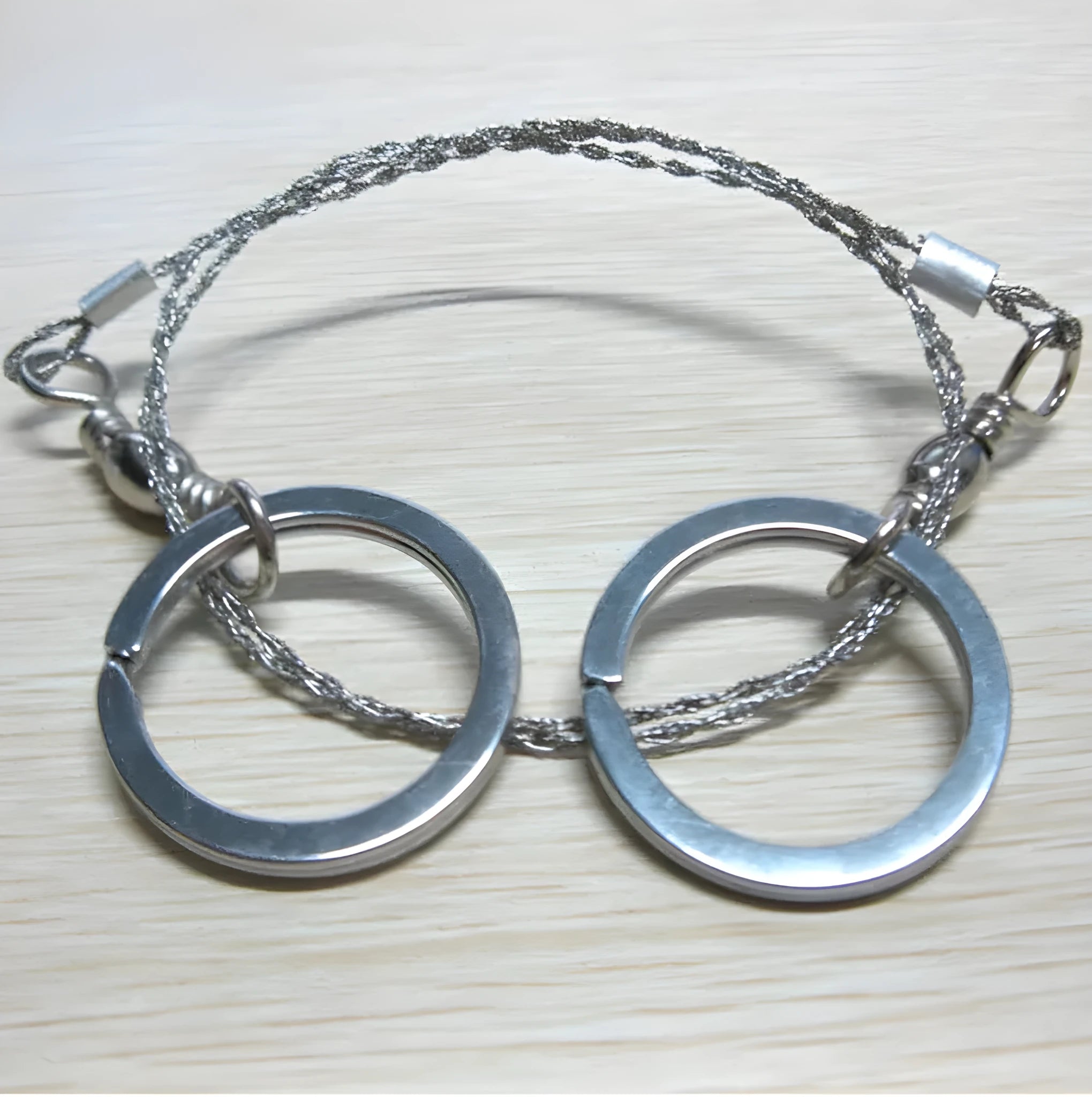 Stainless steel survival wire saw with thumb rings for outdoor cutting