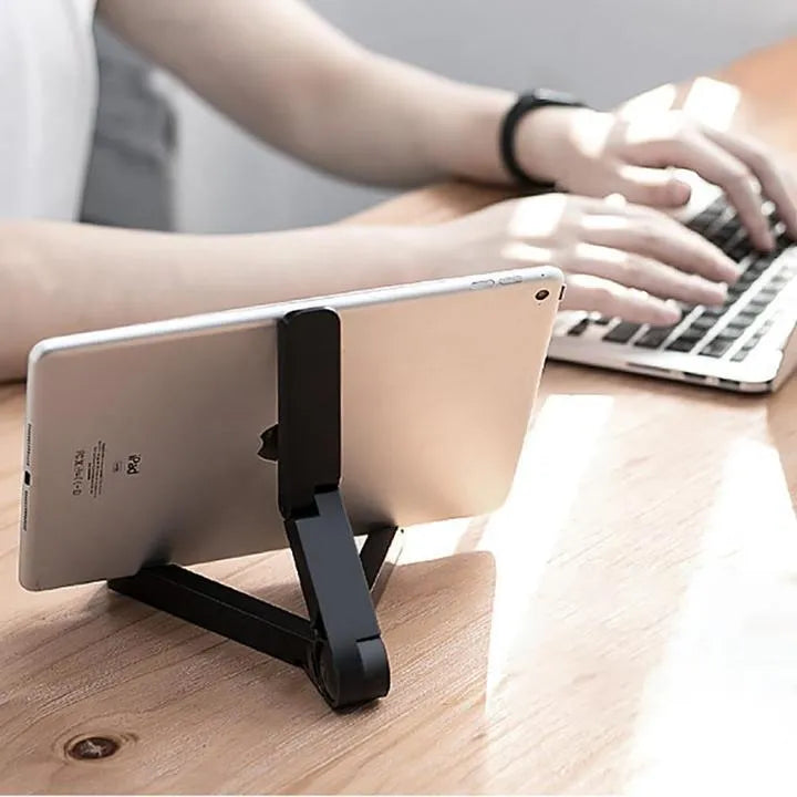 Black foldable tablet holder supporting tablet in landscape position on desk