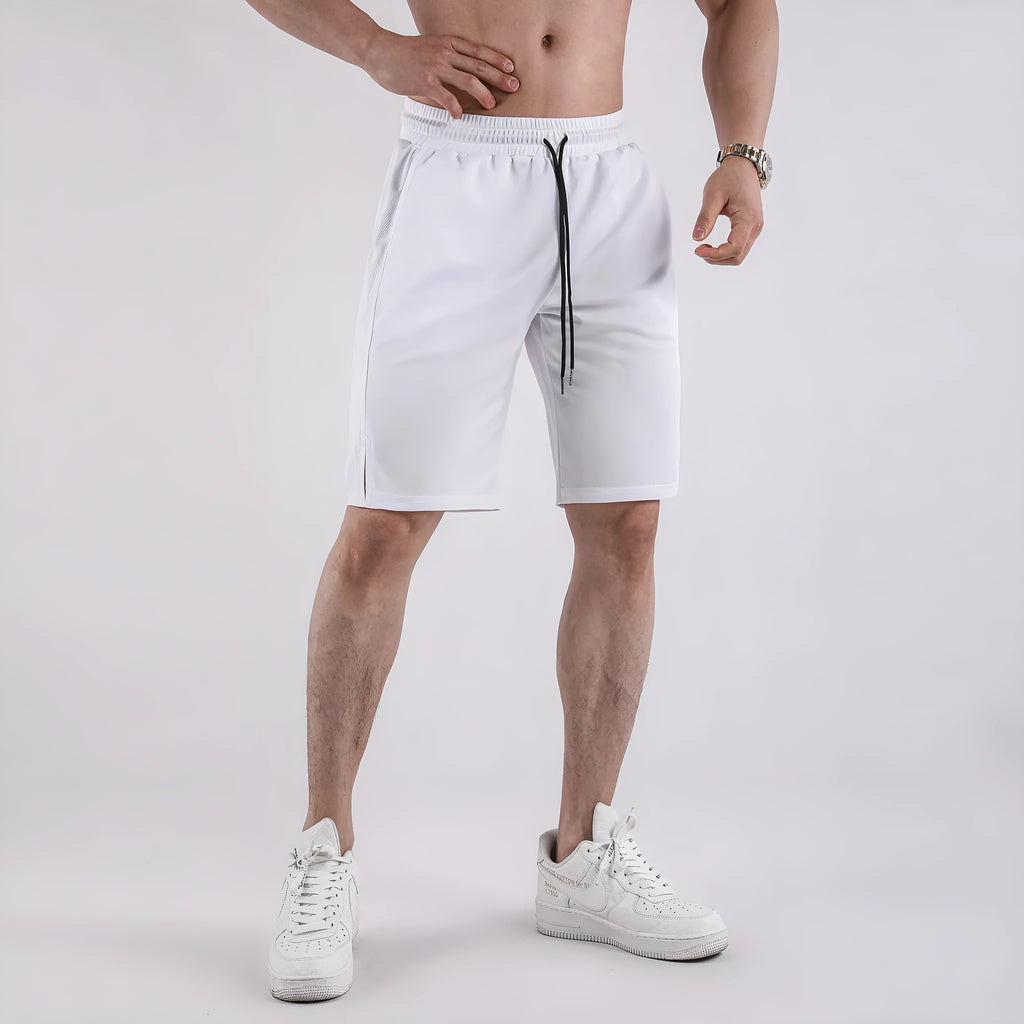 Man wearing black loose-fit quick-dry mesh fitness shorts with an elastic waistband.