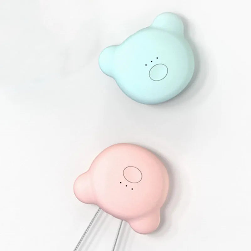Mini USB air purifier pendant on a necklace, shown in pink colour with charging cable.