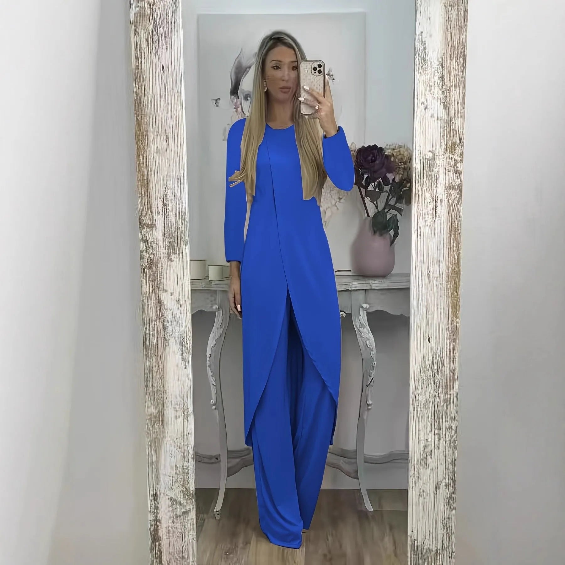 Casual long sleeve top and trousers lounge set in black, shown on a hanger