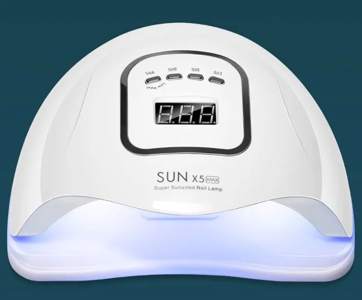 White nail polish quick-drying baking lamp dryer with dual UV and LED light sources on a clean surface.