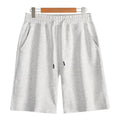Cotton straight leg sports shorts in light grey colour showing relaxed fit and micro-elastic fabric