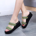 Brown women's bohemian slippers with an adjustable strap and a wedge heel.