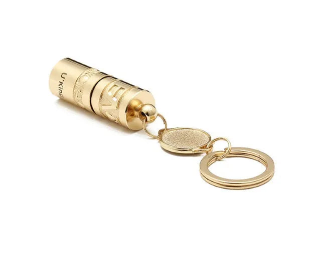 Gold zinc alloy waterproof mini LED flashlight on a keychain.