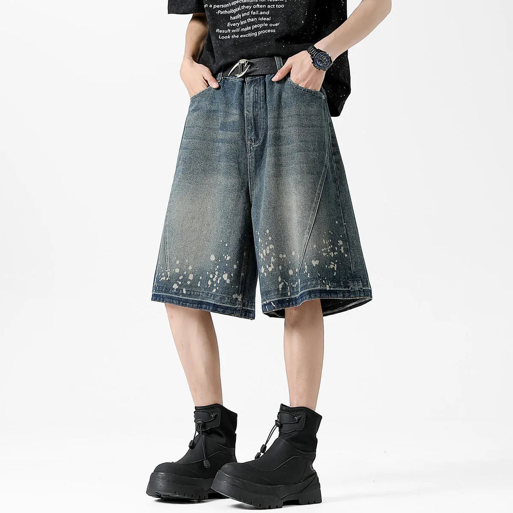 Men's retro blue denim shorts with ripped detailing and splash ink patterns in straight cut design