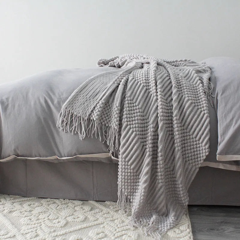 Small light grey polyester blanket folded, showing its texture and 127x170cm size.