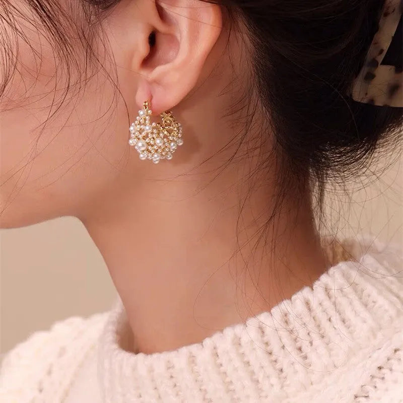 Women's gold flower basket earrings with small beads and pearl inlay details