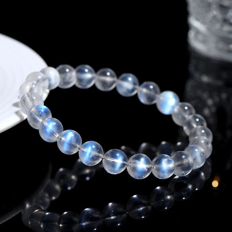 Natural cream coloured crystal bracelet on a wrist showing its simple unisex design and smooth ground beads.