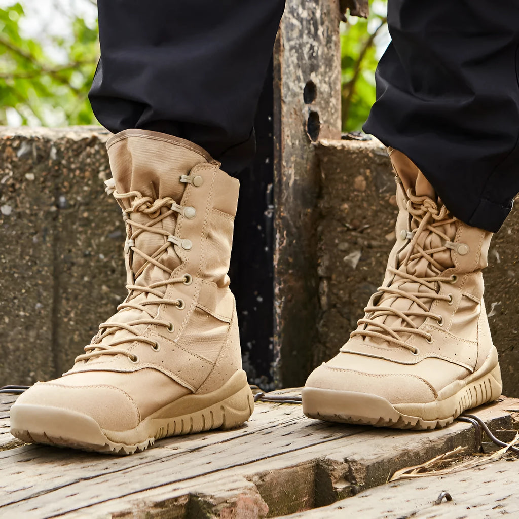 Yulong tactical desert combat boots in black and sand colour on a rocky outdoor terrain.