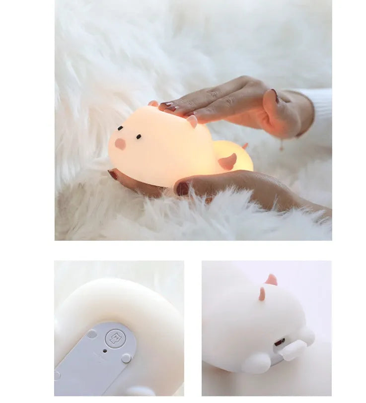 Cute pig silicone night light in Pink with sleeping face design on a wooden table