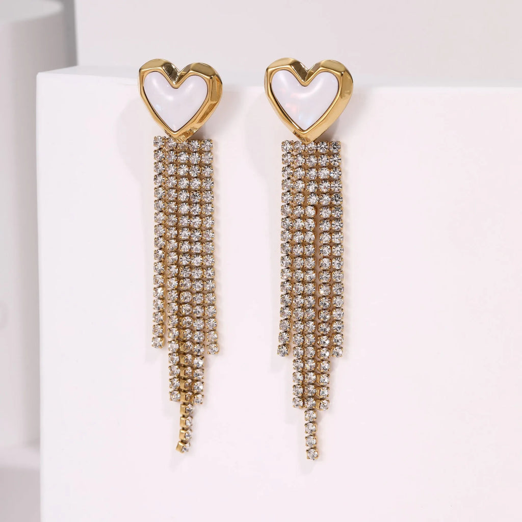Gold-coloured stainless steel earrings with geometric heart, star, and tassel designs on a white background.
