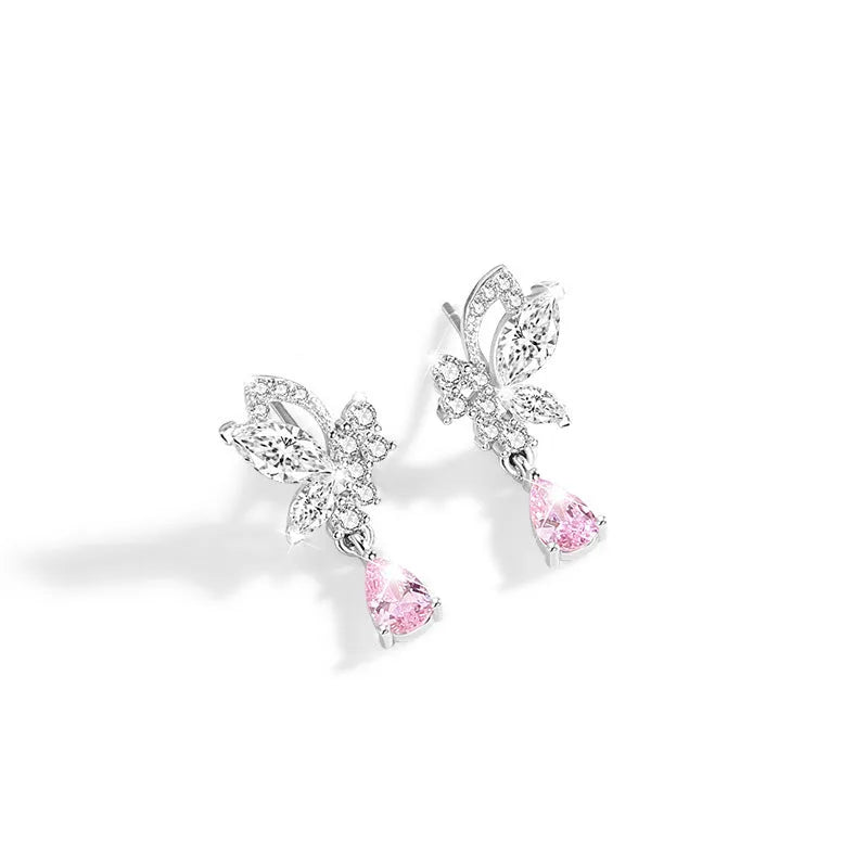 Sterling silver butterfly stud earrings with crystal details on woman's earlobe
