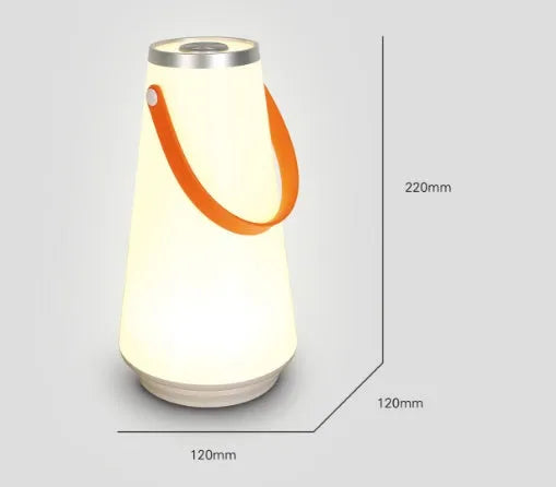 White rechargeable LED lantern night light with USB cable on a table