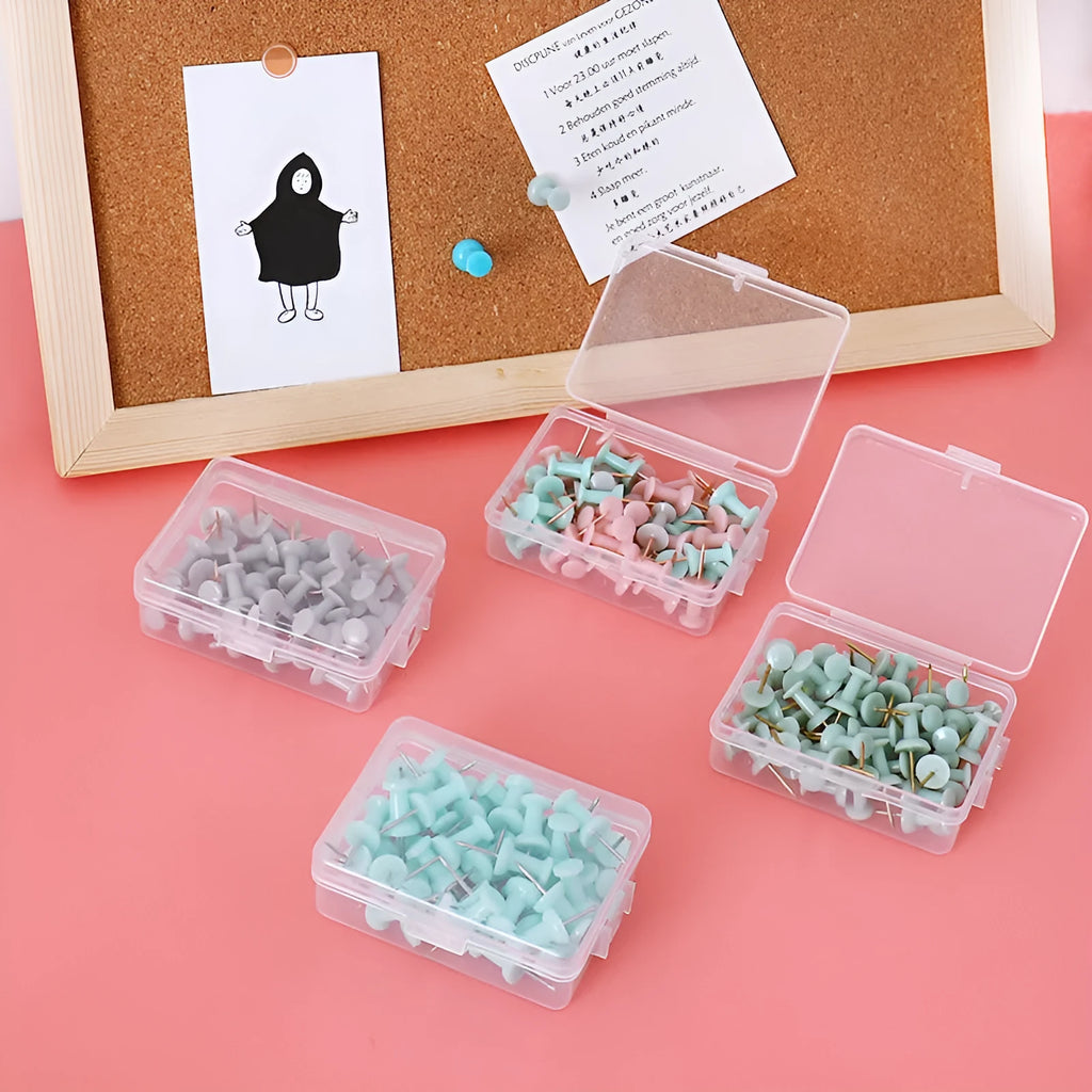 Set of 50 Morandi colour pushpins showing green, grey, and pink tones with different pin head styles on a corkboard.
