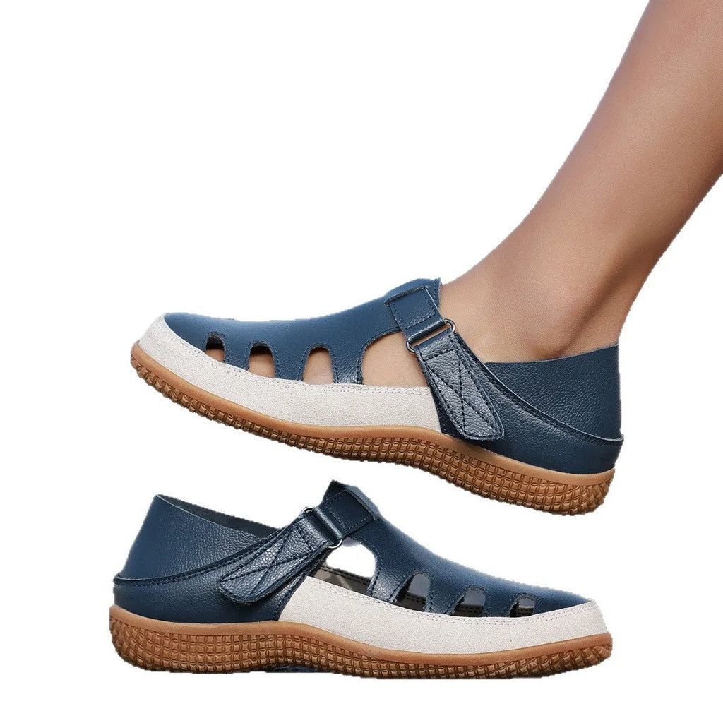 Women's flat sandals with hollow-out toe cap design in blue colour showing thick rubber sole