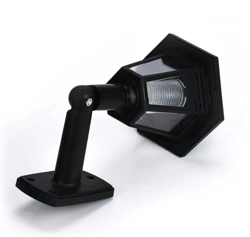 Black hexagonal solar wall lamp with integrated solar panel for outdoor garden or patio lighting