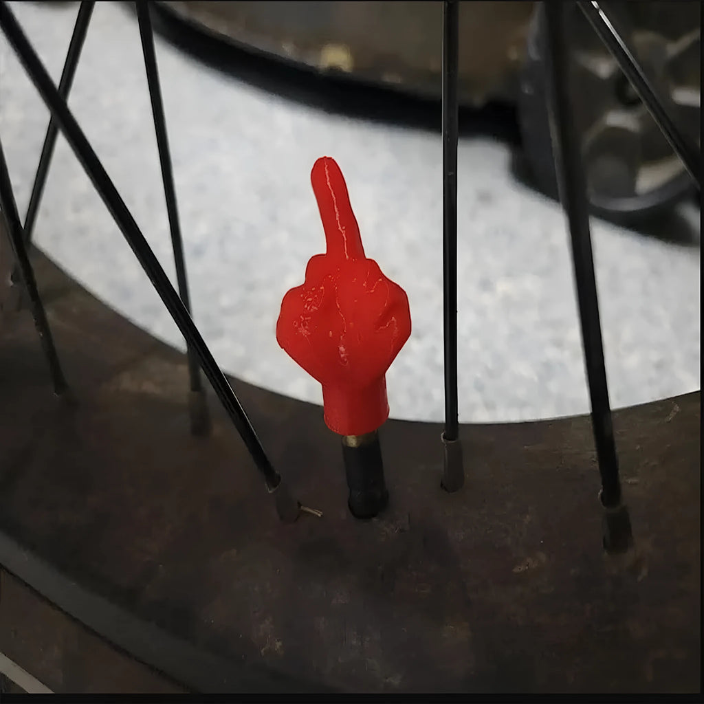 Four latex tyre valve dust caps showing black and skin colour options