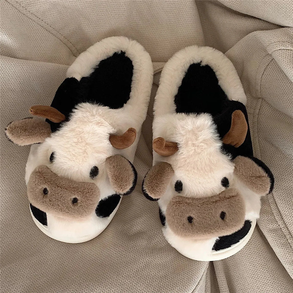White cow print faux fur plush slippers for women with a non-slip textured sole.