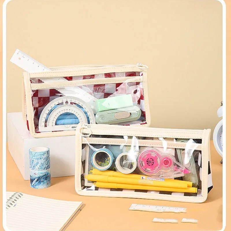 Transparent PVC pencil case with chessboard grid pattern showing pens inside
