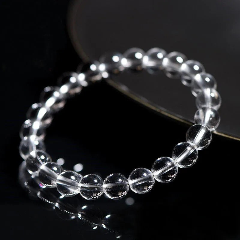 Natural Donghai white water round crystal bead bracelet on a wrist, showing geometric style.