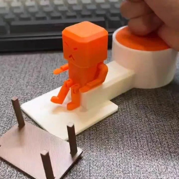 Orange plastic vent decompression table turning toy measuring 16cm wide