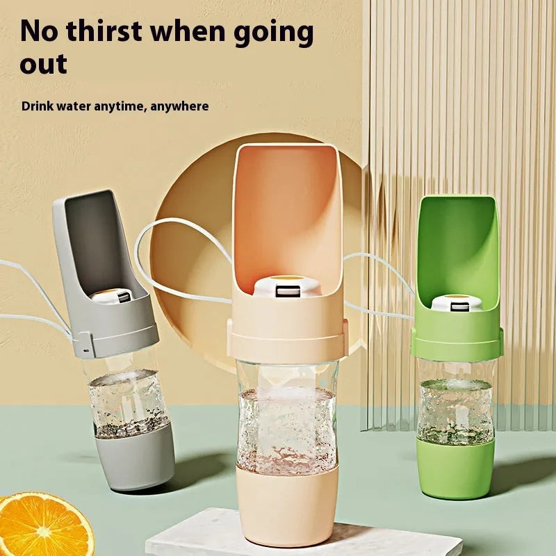 Grey foldable 2-in-1 dog water bottle and feeder with lanyard, showing food and water compartments.