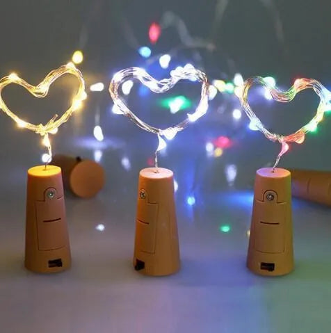 2 metre long copper wire LED light string wrapped around a glass wine bottle with 20 small white LEDs.