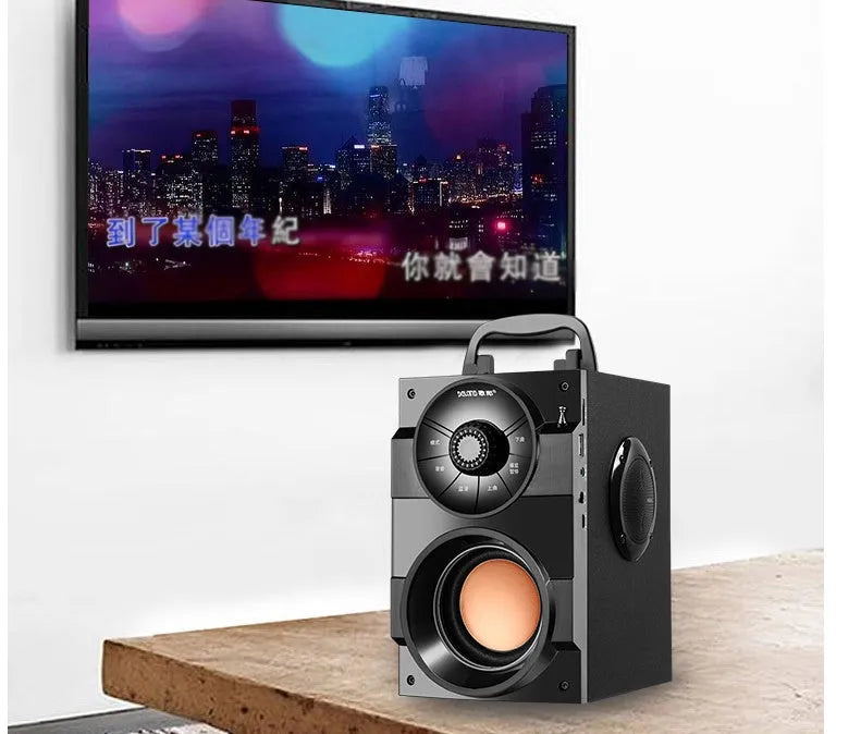 Black portable mini audio system with subwoofer, connection cable, and charging accessories