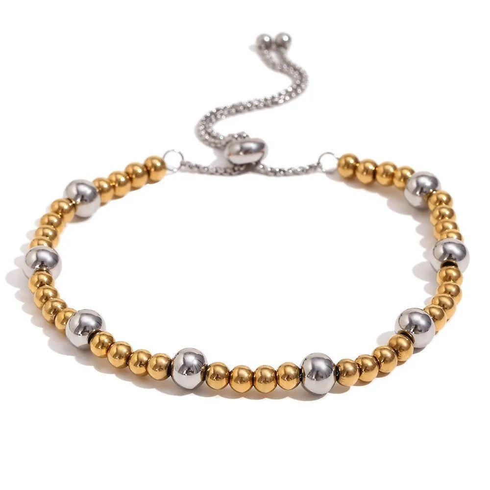 Geometric gold electroplated jewellery set showing earrings, bracelet and necklace with rounded ring elements