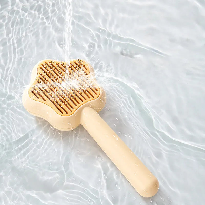 Green and yellow self-cleaning stainless steel cat comb grooming tool measuring 20 cm.