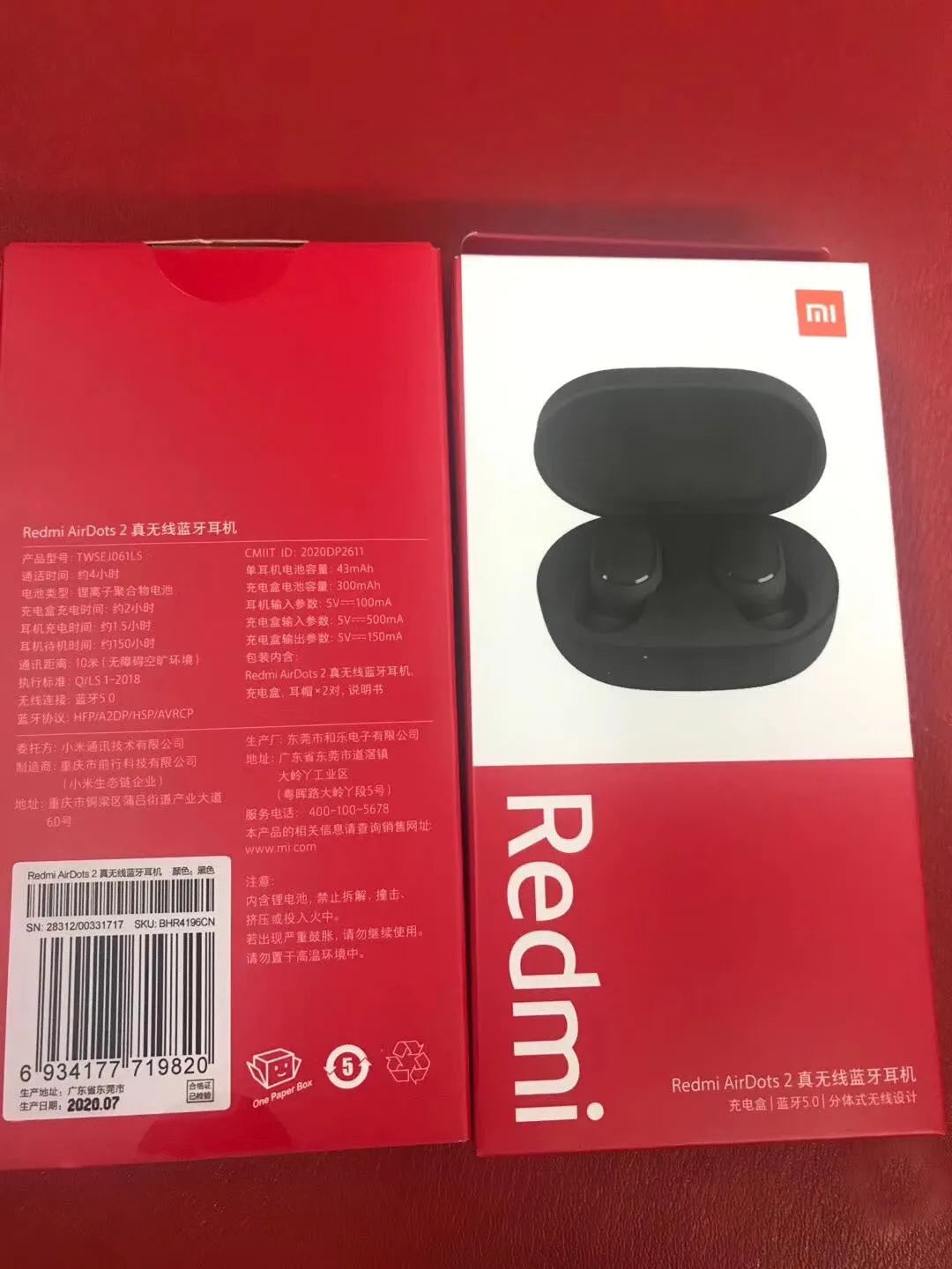 Black Redmi AirDots true wireless earbuds and charging case on a white background.