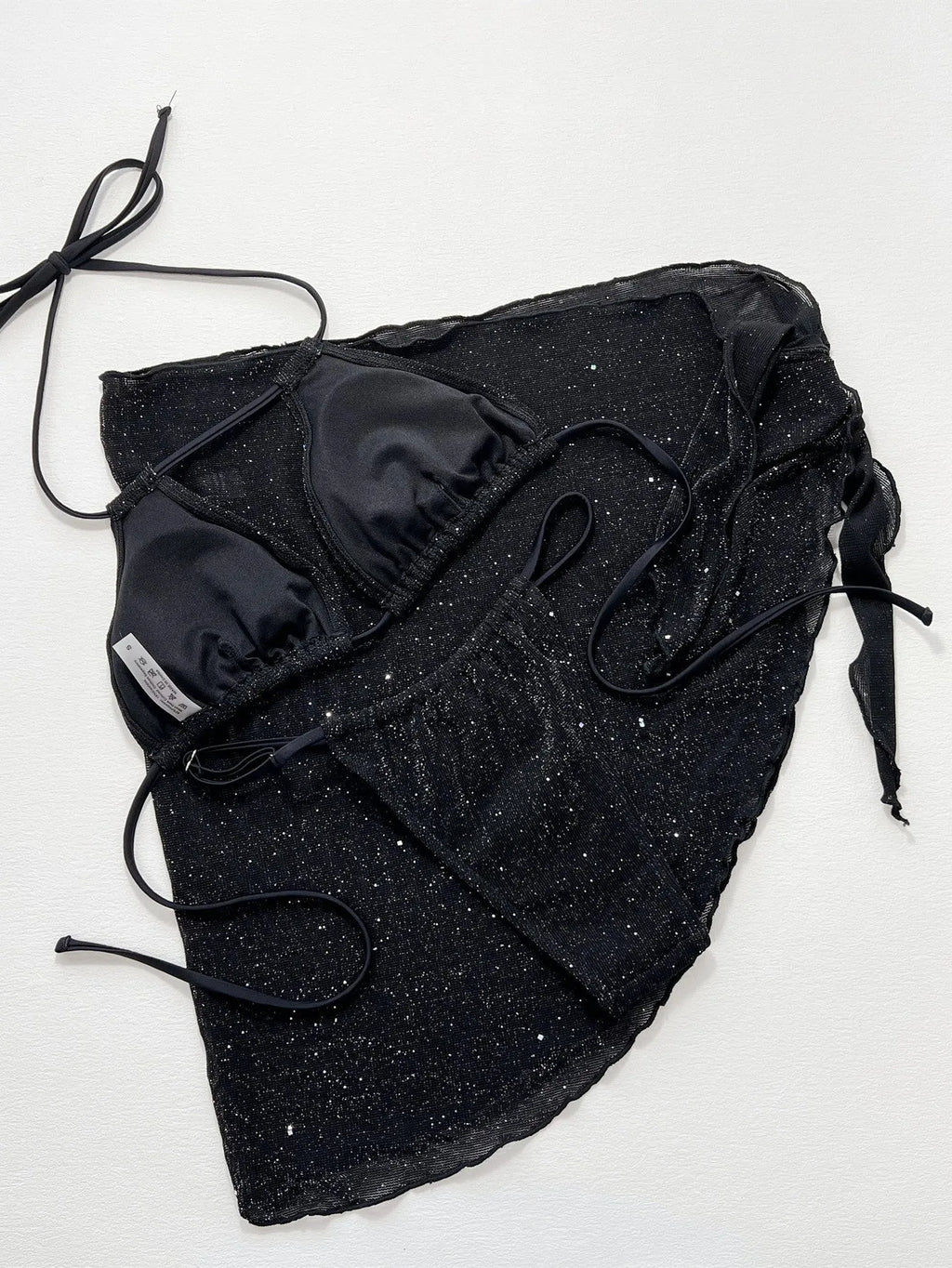 Black three-piece polyester bikini set with top and shorts on a size chart showing S, M, L.