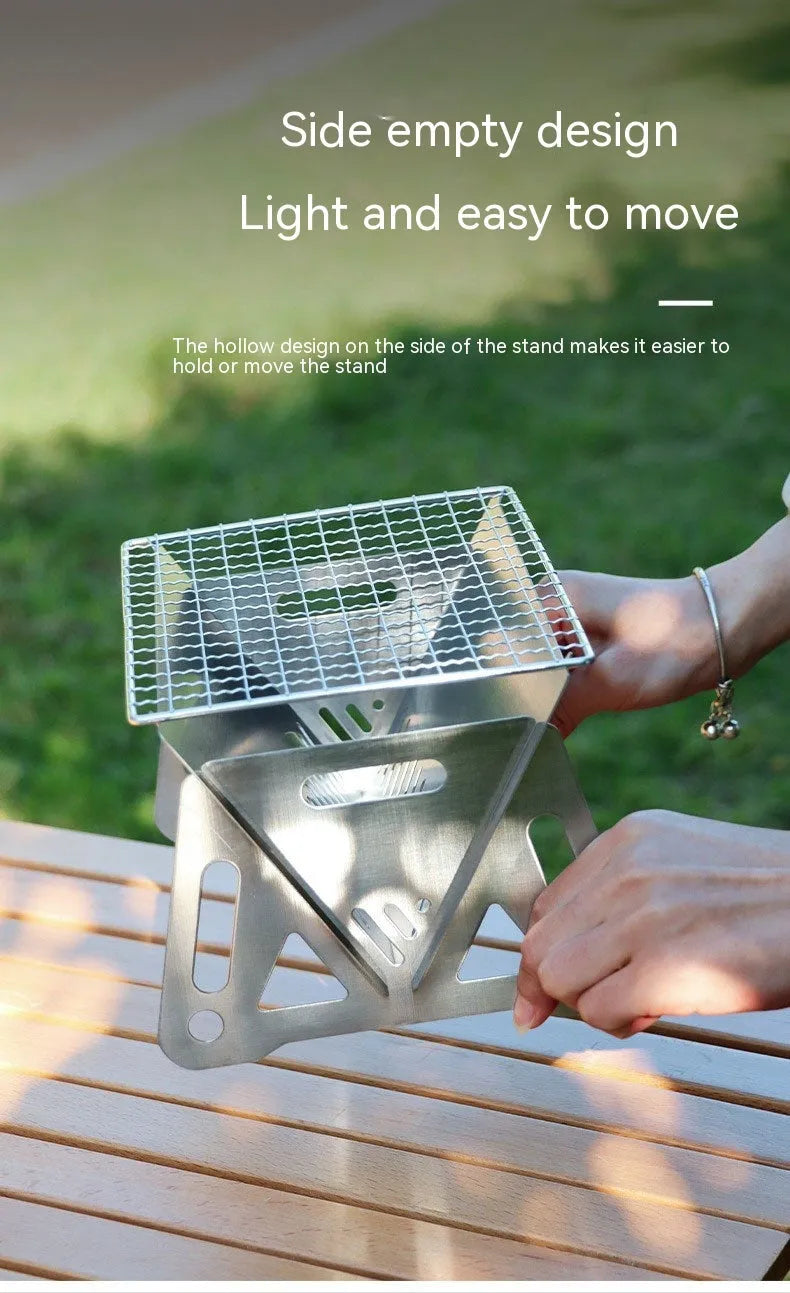 Folding stainless steel outdoor barbecue oven with grill rack and storage bag.