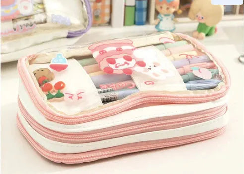 Transparent TPU pencil case with Korean-style pink rabbit design showing visible pens inside
