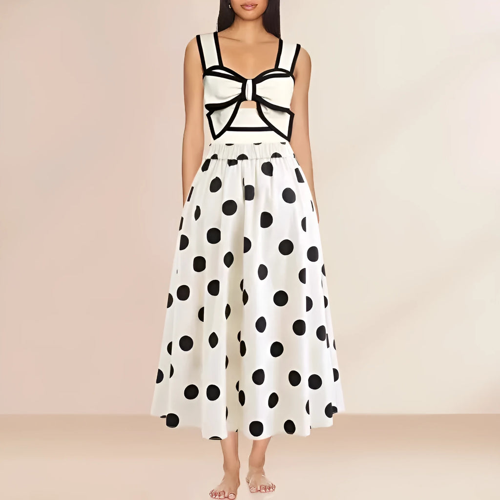 Women's black one-piece swimsuit with a white round skirt and a bow at the centre front