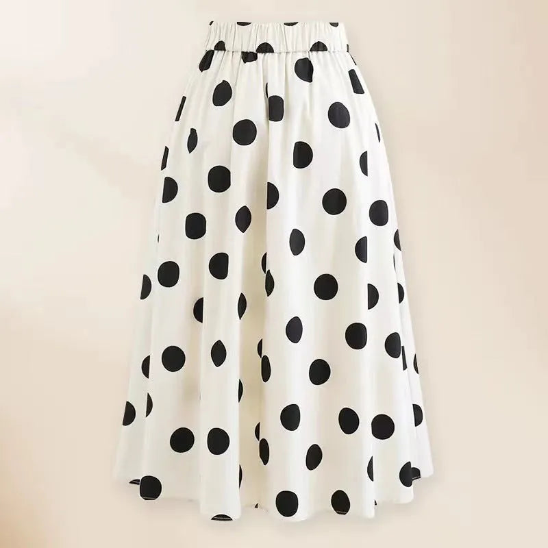 Women's black one-piece swimsuit with a white round skirt and a bow at the centre front