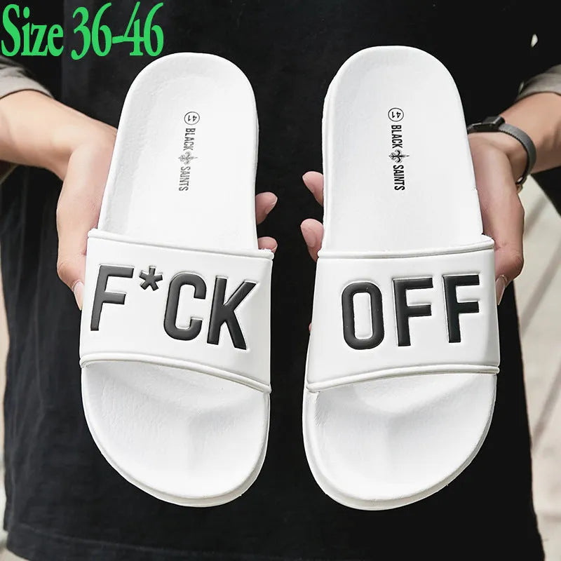 Men's black open-toe slippers with a rubber sole and viscose upper, shown next to a white pair.